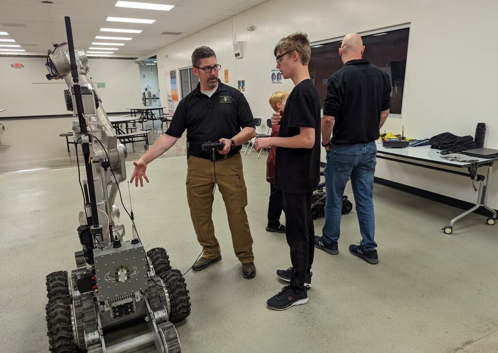 instructor teaching about robotics to a student in the CTEC aviation program