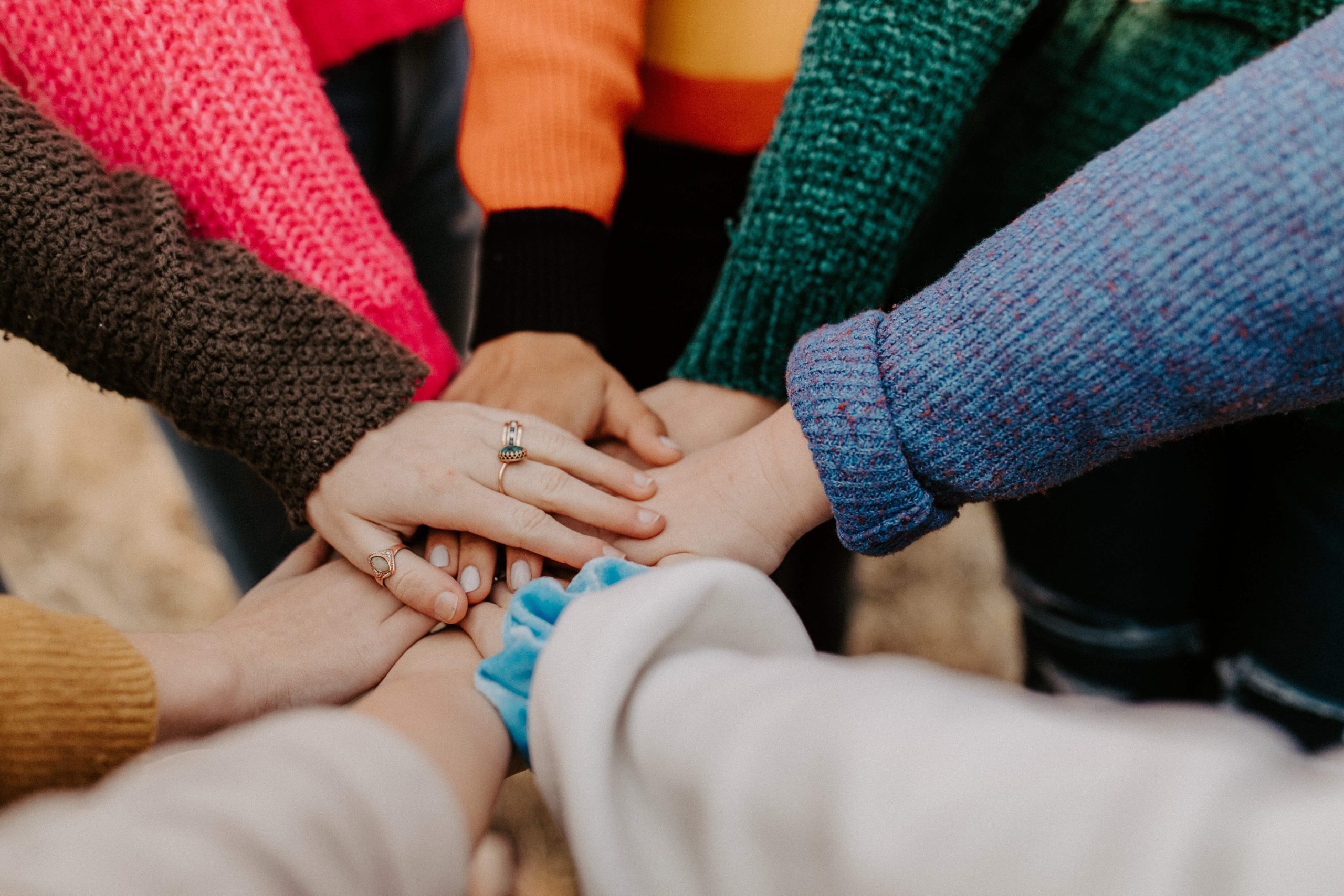 Image of arms and hands together in a group